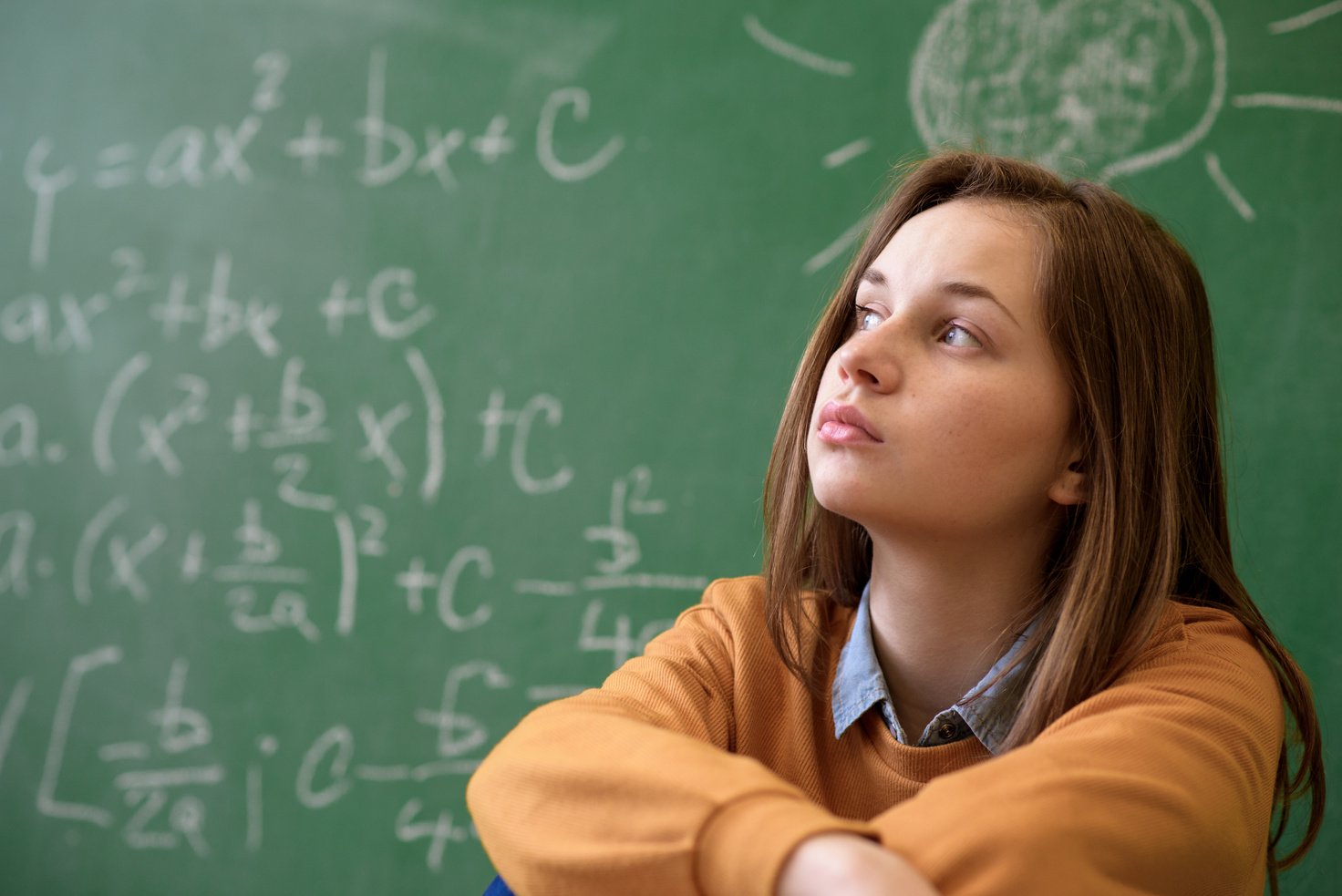 Teenager girl in math class overwhelmed by the math formula. Pressure, Education, Success concept.